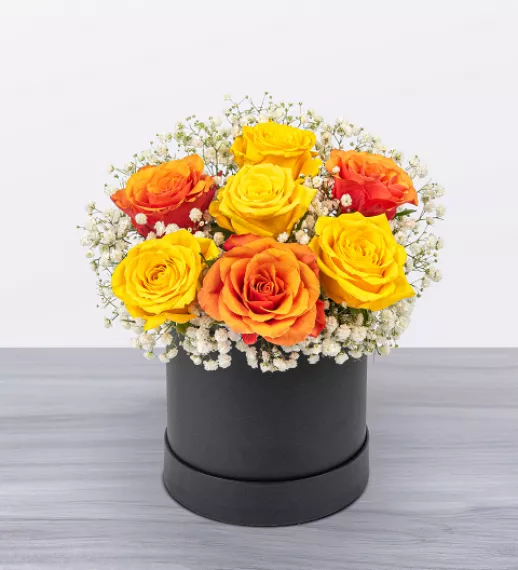 flowers - Sunset Supreme, £43.99 - Lively hues of yellow and orange make this floral display a true delight.