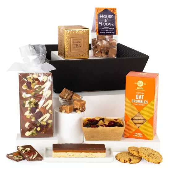 hampers - Tea and Treats, £24.75 - Presented in a black kraft tray, this gift hamper is packed full of a wonderful selection of sweet treats to enjoy with a nice cup of tea!