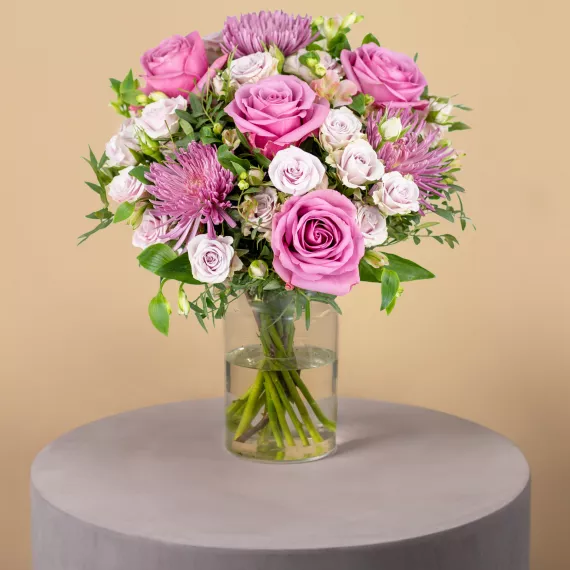 flowers - Pink & Lilacs, £39.99 - This charming bouquet showcases a beautiful blend of pink and lilac roses, chrysanthemums, and alstroemeria, all complemented by lush seasonal foliage.