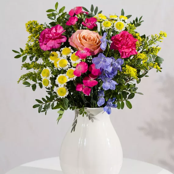 flowers - Garden Mosaic, £28.50 - A beautiful combination of a striking blue Delphinium, soft peach Roses, and lush green foliage paired with vibrant cerise Spray Roses.